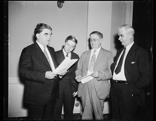Son of Mine Workers' Chief learning business. John L. Lewis, Jr., (second from left) son of the president of the United Mine Workers, listens in as his father marshalls followers in defense of the Guffey Coal Bill, now before a subcommittee of the Ways and Means Committee. From the left: John L. Lew