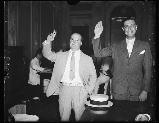 Ready to testify. E.W. O'Brien, left and R.P. Herron, utility representatives being sworn in Thursday at the Senate lobby investigation. Both men are implicated in the anti-holding company bill "telephone directory wire" barrage that flooded Capitol Hill