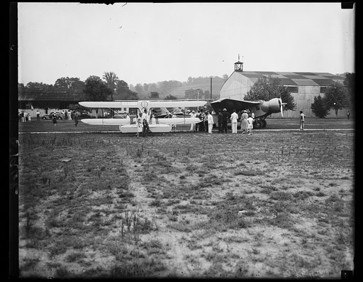 Famed flier averts crash with notables aboard. This picture was taken a moment after Clyde Pangborn, world famous flier, in attempting to taxi down the field for a take-off, clipped wings with another ship on the field. At the time of the accident, Pangborn had as passengers, Asst.Sec of War, Harry 