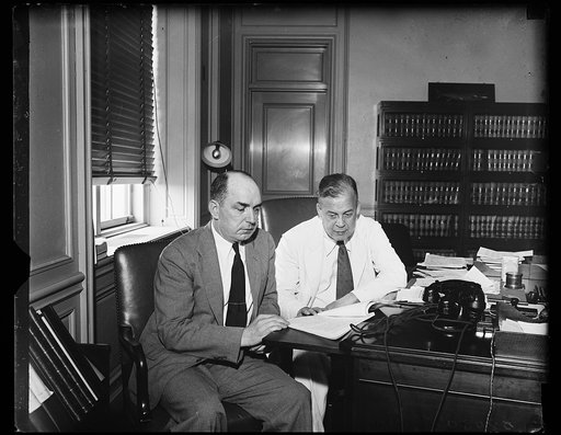 Truck expert and his Chief. John Rogers, left, newly appointed Director of the Bureau of Motor Carriers in the I.C.C., and Joseph Eastman, Federal Coordinator of announcement of the appointment of Rogers. Rogers has been executive assistant to Eastman since 1933. He formerly was with the Engineering