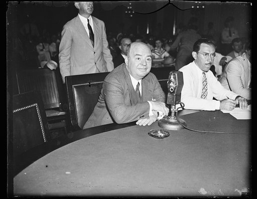 Keep your foot off my chair. Howard C. Hopson, reputed Association Gas & Electric Co. Boss, is the subject of intense questioning when brought before the House Lobby Investigation Committee after many days of search. 8/13/35