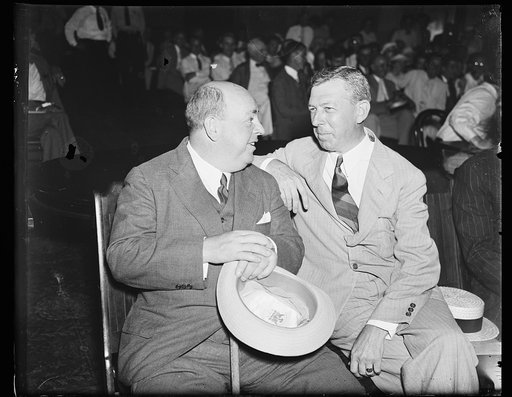 On advise of counsel. Howard C. Hopson, left, long missing witness for the House Lobby Investigation Committee, confers with his counsel, William Hill of Boston, when he makes a belated appearance on the "Hill." 8/13/35