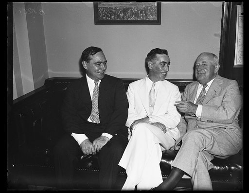 Rhode Island's new congressman. Republicans had a quiet little celebration as Chas F. Risk, center, prepared to take his seat as Rhode Island's Republican congressman. From the left: Joseph W. Martin, Jr., R. of Mass; Risk, and Minority Leader Bertrand H. Snell of New York. 8/19/35