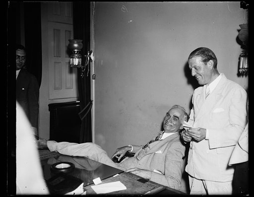 Making way for Roosevelt bills. Speaker Joe Byrns, seated, tells a group of newspaper men that everything will be set aside in the House to make way for the president's four point temporary legislative program made necessary by the Supreme Court's NRA decision. The Speaker said that the Congress wil