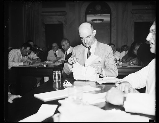 Submits telegraphic evidence [...] Luther Coleman, Postal Telegraph Mgr. at York, Pa., hands over original copies of telegrams sent to congressmen which opposed Wheeler-Rayburn Utility Bill. This picture taken at Tuesday Senate Lobby inquiry. Sen. Hugo Black (D.Ala), Sen. Sherman Minton (D.Ind) and 