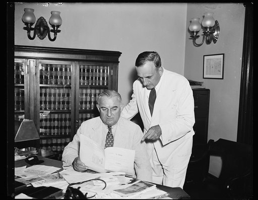 Coal bill authors in Friday confl [...] Sen. Joseph F. Guffey (D. of Pa) at his desk in the Senate office bldg, receives a visit from Rep. Buell J. Snyder (D. of Penn) seen standing, Friday a.m. The Guffey coal bill, which Snyder co-authored to stabilize the bit[...] coal indus. has been lately side