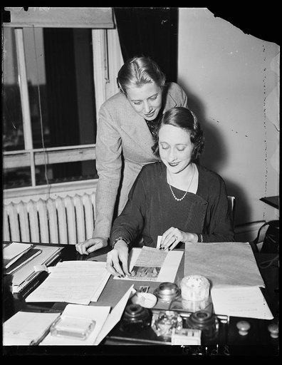 Wash. D.C. Working on housing survey figures. Miss Fritzi Honick, left, and Helen Hasting, Secretary to Peter Grimm, who is making a housing survey, are compiling data which shows a surplus of less than 4 percent in housing "East" of the Mississippi. A plan is being worked out in the Treasury Depart
