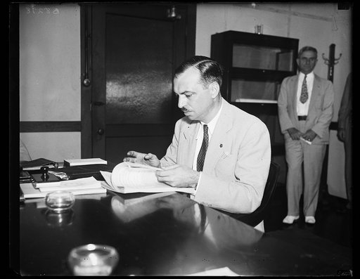 Wash. D.C. New Federal Trade Commissioner. Robert E. Freer, 39-year-old Attorney with the Federal Coordinator of Transportation, photographed at his desk as he took over his new duties as Federal Trade Commissioner. He fills the unexpired portion of the term of George C. Matthews, retired. It extend