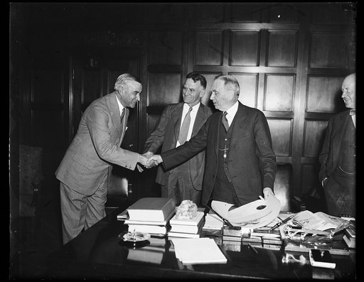 Wash. D.C. Draper gets Commerce post., Ernest G. Draper, left, of New York City, about to receive his commission as Assistant Secretary of Commerce from Secretary Daniel C. Roper. From the left: Draper, Assistant Secretary J.M. Johnson and Secretary Roper. 9/12/35
