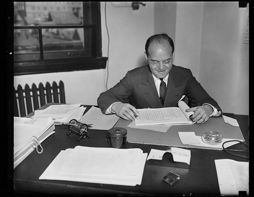 Wash. D.C. To push A.T. & T. quiz. Samuel Becker of Milwaukee, photographed at his desk where he is talking over his duties as special assistant counsel for the Federal Communications Commission where his telephone investigation. His salary is $9,000 a year. 10/4/35