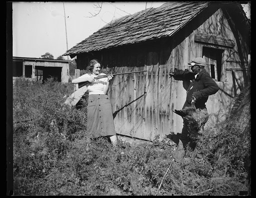 Objects to workers. Edna Morris, who lives within a few hundred feet of the government-owned "Tugwelltown" being constructed near Washington by Rehabilitation Administration, arms herself to protect her property against what she termed the "thieving" of the workers on the project. Many people living
