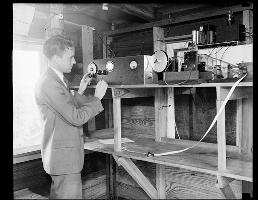 Receiving stratosphere weather data. B.W. Brown, of the U.S. Bureau of Standards staff, is shown here at the radio receiving set which captures signals from a new type of transmitter used in gathering meteorological data from an altitude of 14 miles