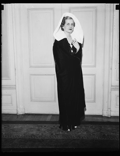 Juliet gown. Mrs. Nelson Elgin wearing a Juliet gown at the style show sponsored by the Dorthy Hancock Chapter of the Daughters of the American Revolution at the Raleigh Hotel. The gown is black and white with an ermine hood. 10/23/35