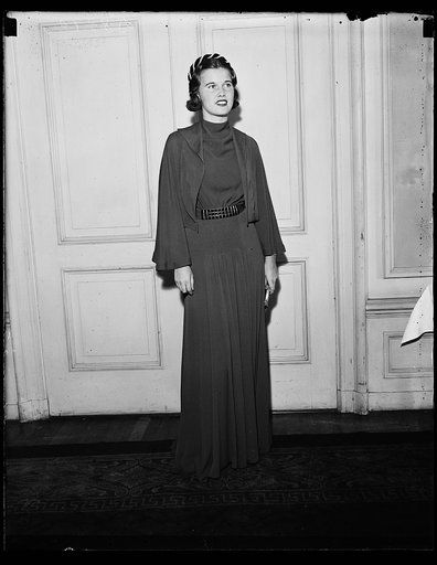 Tea dress. Miss Frances Glover shown in a tea dance dress of red flat crepe. The style show was sponsored by the Dorothy Hancock Chapter of the Daughters of the American Revolution at the Raleigh Hotel. 10/23/35
