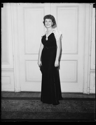 Diplomat model. Miss Amelita Alfaro, daughter of the minister of Panama modeling an evening gown of black velvet and white starched lace collar at the style show sponsored by the Dorothy Hancock Chapter of the Daughters of the American Revolution at the Raleigh Hotel. 10/23/35