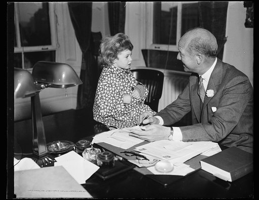 A young associate. Peter Grimm, president of William A. White & Sons of N.Y.C., and at present Assistant to the Secretary of the Treasury while he directs a housing survey, poses for photographs with Miss Jan Wilmerding, daughter of Lucius Wilmerding, Jr.