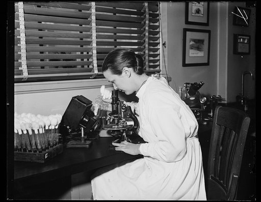 Technician. Miss Edna Smith, Bacterial-Logical Technician in the Public Health service, photographed as she is working with the effect of irradiation of bacterial. 10/29/35