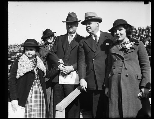 Big game at big game. Left to right, Miss Anne Farley, Miss Betty Farley, Postmaster General James Farley, Frank C. Walker head of the National Emergency Council and his daughter Miss Laura Walker at Navy-Notre Dame game