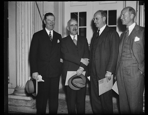 Big talk on little houses. These high officials of the New Deal's housing family photographed as they concluded a conference with President Roosevelt. From the left: Stewart McDonald, head of the [FHA?]; Secretary Henry Morgenthau, Jr., Morris L. Coske, head of Rural Electrification, and Peter Grimm
