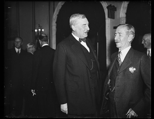 Champion mustaches. Sir Ronald Lindsay, left, Ambassador from England, and Secretary Claude Swanson sport the most outstanding mustaches in official Washington. It is not often that an opportunity for comparison occurs. This occasion was the luncheon given by the Secretary for the visiting Vice Admi