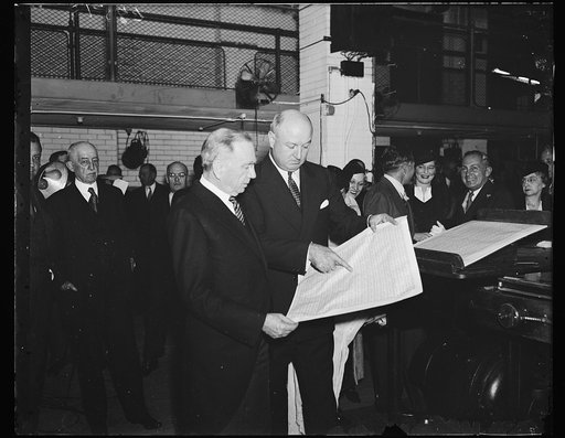 Stamps ready for ocean hops. The new Trans-Pacific flight stamps, to be used on the Pan-American Airways run from San Francisco to the Orient, are coming off the presses of the Bureau of Engraving. Secretary Daniel C. Roper, left, and PMG James Farley inspect a sheet of the stamps as the pressed tur