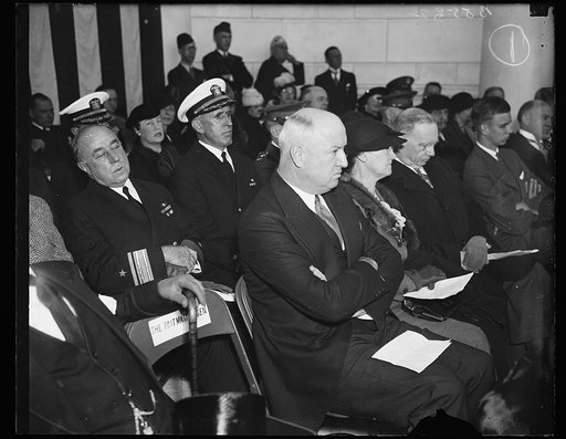 Cabinet members at Armistice Exercises. Postmaster General James A. Farley, left, photographed with Secretary and Mrs. Daniel C. Roper at the Armistice Day exercises at Arlington cemetery where President Roosevelt delivered an address at the Tomb of the Unknown Soldier. 11/11/35