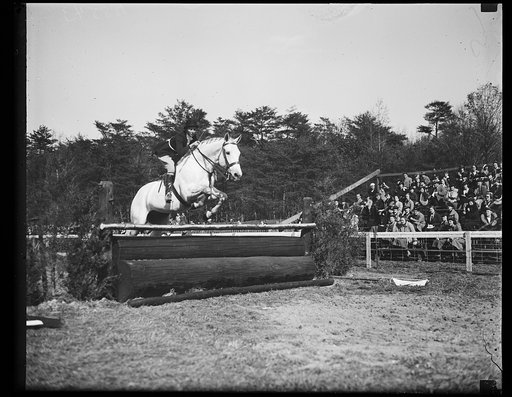 Wash. D.C. Mrs. John Hay Whitney takes Prinprillis over a jump at the Inter-American horse show in Washington. 10/26/35