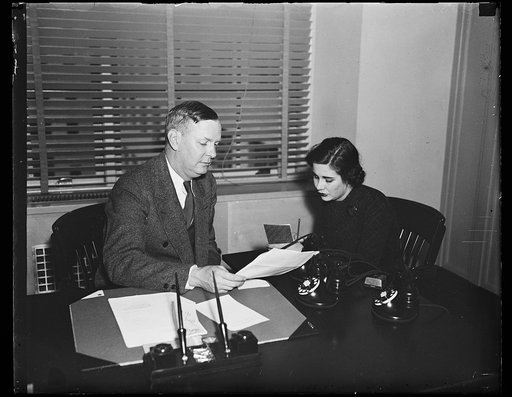 Hitting the ball for Social Security, Wash. D.C. Frank Bane, executive director of the Social Security Board, and one of his secretaries, Miss Frances E. Murray, are busy going through organization matters as an appropriation is awaited which will enable the board to round out its plans. The filibus