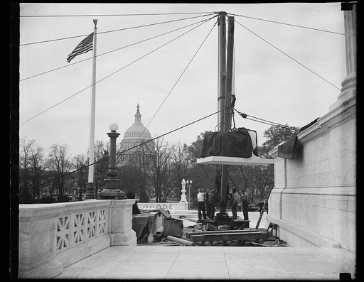 Wash. D.C. Ready for lift. This photograph shows the statue as it is made ready for the "ride up" to the place where it will rest beside the entrance to the new U.S. Supreme Court building. The Capitol dome is in the background. 11/6/35