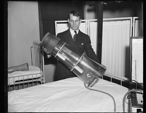 Leg saver. Chester Antos, student at Georgetown University medical school, photographed with the newly devised Emerson suction pressure apparatus which designers believe will prevent amputation in many cases. The mechanical "boot" is to be used in treatment of severe cases of peripheral vascular dis