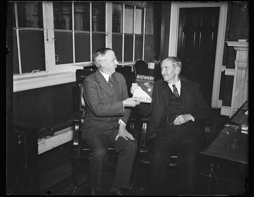 Wash. D.C. First bird book., Dr. Gilbert Grosvenor, President of the National Geographic Society, left, presents to Secretary Claude A. Swanson a special copy of "Discovery" by Rear Admiral Richard E. Byrd, writing of his second South Polar expedition. 11/22/35