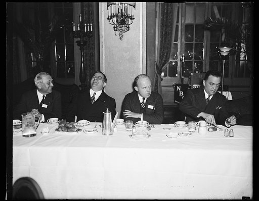Wash. D.C. Funny. Mayor F.H. LaGuardia, right, finds something quite amusing as he sits beside Mayor Howard W. Jackson of Baltimore, at the luncheon given the U.S. Conference of Mayors at the opening session here today. Mayor LaGuardia eveidently is NOT thinking about the relief