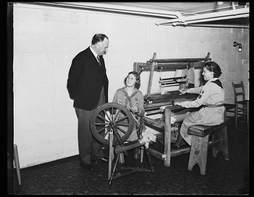 Wash. D.C. Danish Minister visits Girl Scouts. Otto Wedsted, Minister from Denmark, visits the National Girl Scouts "Little House" in Washington where he was greeted by Rosemary Tear, troop #16, center, and June Brown, troop #24. The weaving is part of the craft work of the Girl Scouts in Washington