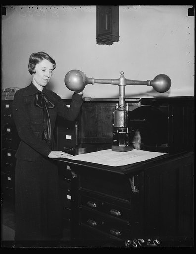 BIG SEALER. Miss Helen V. Schroeder, clerk in the State Department's Appointment Section, is quite a sealer, affixing the Great Seal of the United States to about 1,200 documents per year. This is the only machine in the world which will place the Great Seal of the United States on a document