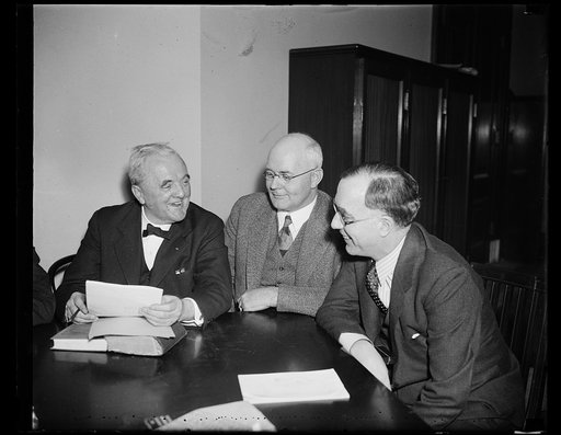 Group at table; George Norris, left