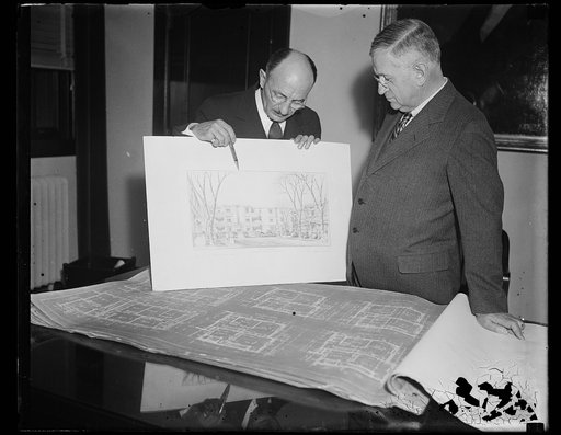 Harold Ickes, right, viewing architectural drawings