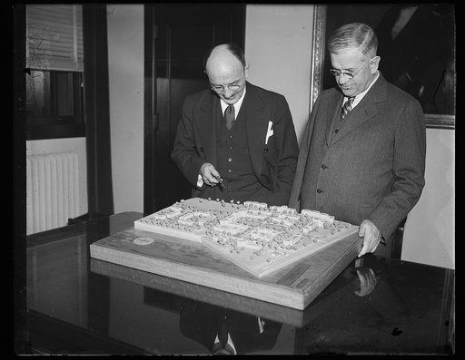 Harold Ickes, right, viewing architectural model