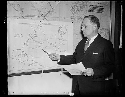 Man with chart showing North Atlantic Ocean