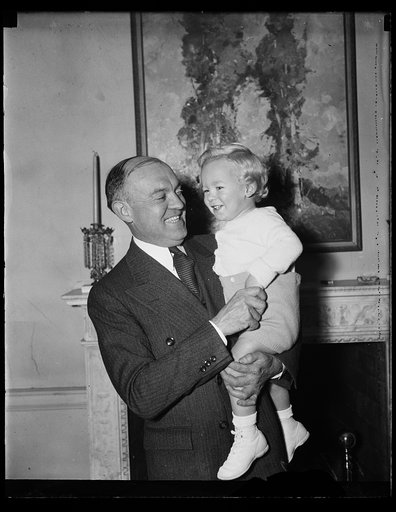 Harry Woodring holding child