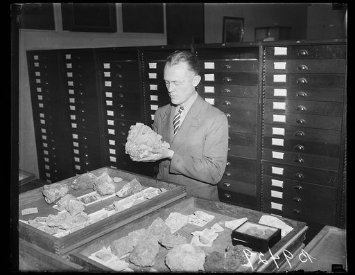 Man examining rock specimens