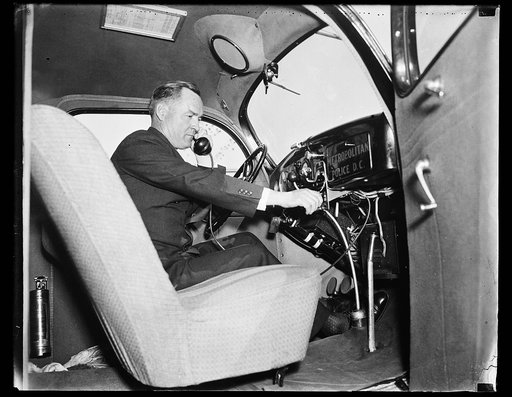 Man using phone in Metropolitan Police D.C. automobile. Washington, D.C.