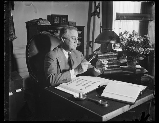Franklin Roosevelt looking at stamps