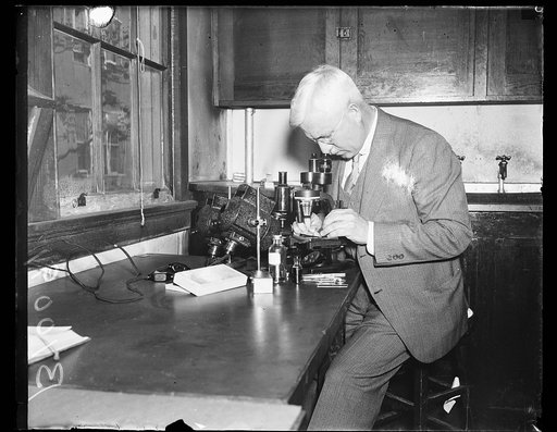Man using microscope in laboratory