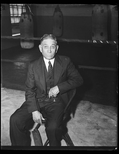 Man seated in boxing ring