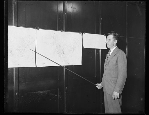 Man pointing to weather maps