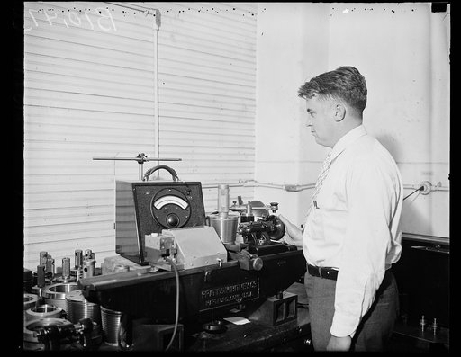 Man with machinery/instrument made by Pratt & Whitney Co., Hartford, Connecticut
