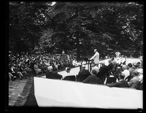 PRESIDENT ROOSEVELT ADDRESSES WELFARE BODY CONFERENCE AT WHITE HOUSE. A TWO DAY CONFERENCE OF THE 1933 MOBILIZATION FOR HUMAN NEEDS OPENED IN WASHINGTON TODAY WHEN PRESIDENT ROOSEVELT ADDRESSED THE GROUP ON THE LAWN OF THE WHITE HOUSE. ON THE PRESIDENT'S RIGHT IN THE PICTURE CAN BE SEEN MRS. ROOSEVE