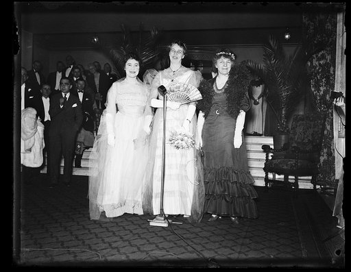 AS THEY DRESSSED IN THE 1900'S. THESE THREE WOMEN, MRS. MARY HARRIMAN RUMSEY, NEW YORK MILLIONAIRE, LEFT, MRS. FRANKLIN D. ROOSEVELT, AND MRS. ISABELLA GREENWAY, REPRESENTATIVE FROM ARIZONA, ATTENDED THE JUNIOR LEAGUE BALL AT THE MAYFLOWER HOTEL IN WASHINGTON FRIDAY NIGHT IN THE GOWN THEY WORE THE N