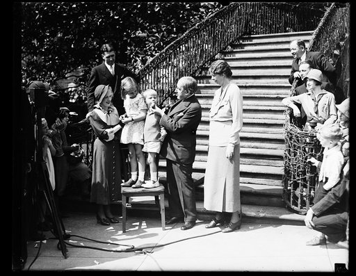 SO THAT'S WHERE EGGS COME FROM, AND HOWARD THURSTON, PROFESSIONAL MAGICIAN, PULLS AN EASTER EGG FROM THE MOUTH OF BUZZIE DALL AT THE WHITE HOUSE EGG ROLLING FESTIVALS. THE GROUP, FROM THE LEFT: JANE THURSTON, DAUGHTER OF THE MAGICIAN; SISTIE DALL AND BUZZIE, GRANDCHILDREN OF THE PRESIDENT; MR. THURS