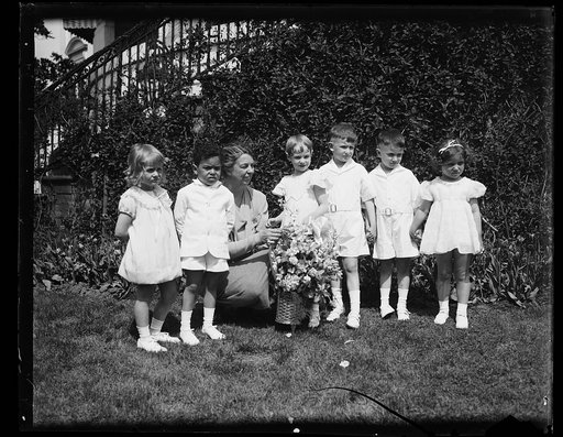 MRS. ROOSEVELT PRESENTED WITH MAY DAY FLOWERS. IN CELEBRATION OF CHILD HEALTH DAY, SIX CHILDREN ARE SHOWN PRESENTING A MAY BASKET TO MRS. FRANKLIN D. ROOSEVELT AT THE WHITE HOUSE LAWN. IN THE PHOTO, L TO R: BETSY SAVIN, 4; MERCER COOK, 3; MRS. ROOSEVELT RITA JOHNSON, 5; DICKIE CALDWELL, 5; TOMMY CAL